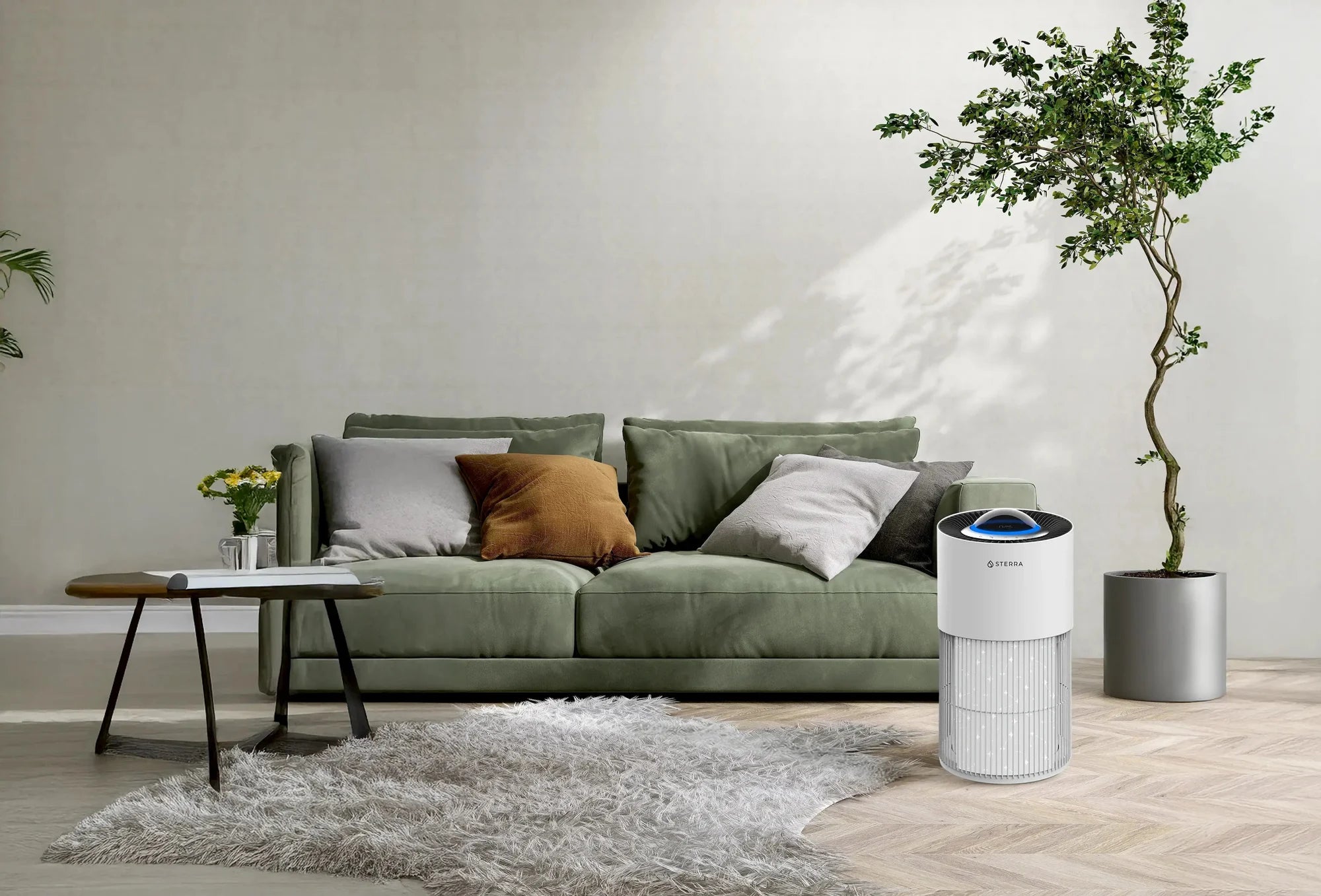 Air purifier beside a green sofa in a sunlit living room